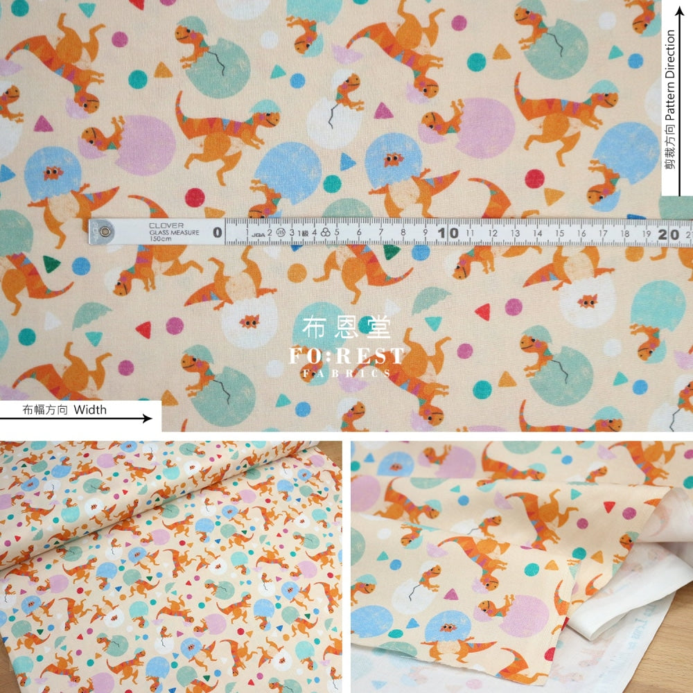 Cotton - Rainbow Hatching Dinosaur Fabric Peach